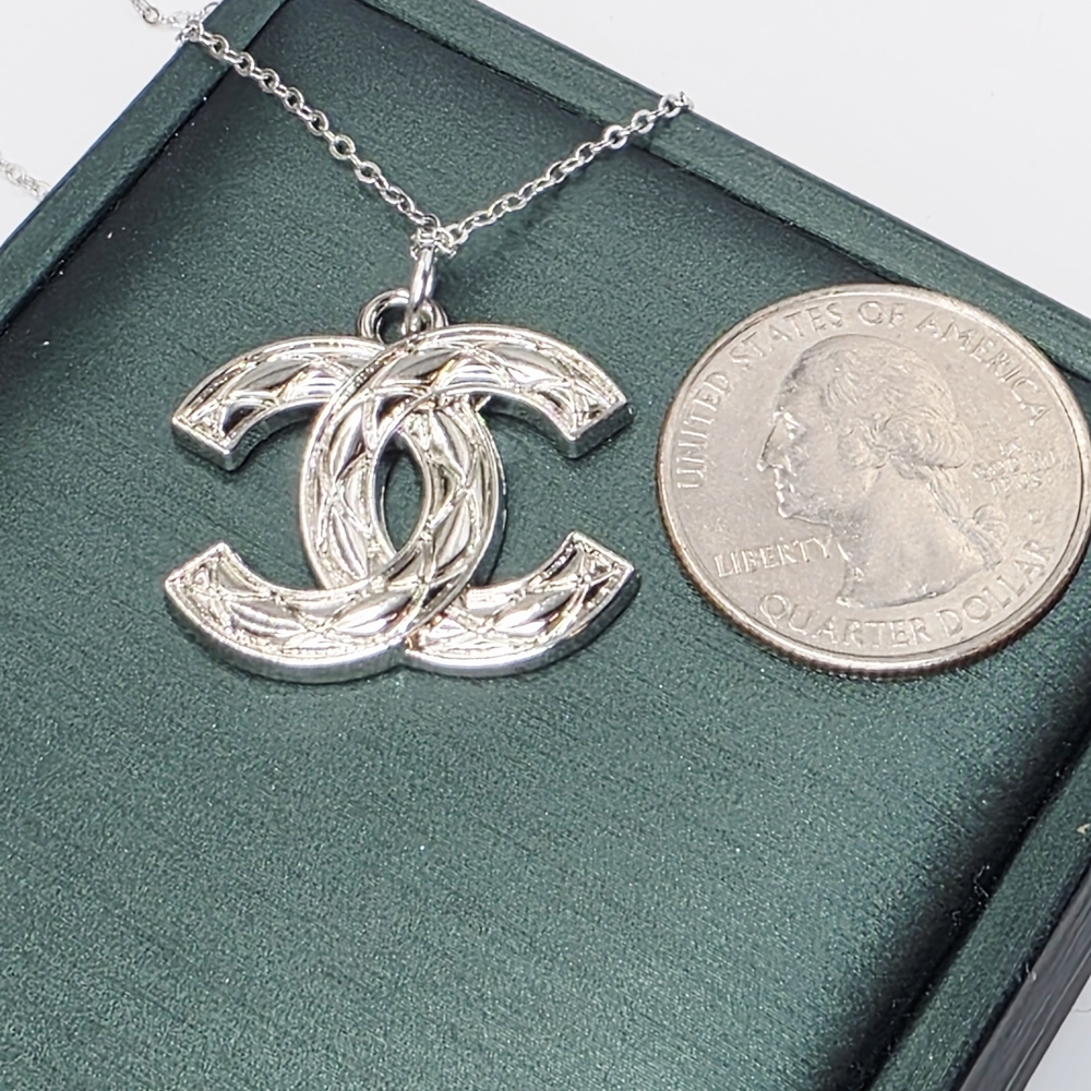 CHANEL Silver Logo Pendant Necklace